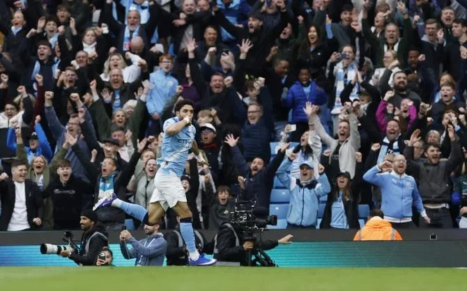 Omar Marmoush celebrates scoring Manchester City's third goal.